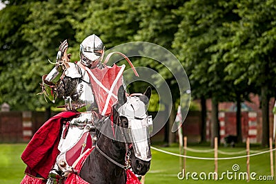 Armored knight suited for battle on horseback Stock Photo